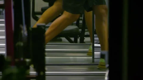 Close-up of legs working out on a leg press machine in 4k slow motion 60fps Stock Footage 285122545