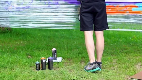 Close-up with legs of young artist man in a black shorts 스톡 동영상 92986341