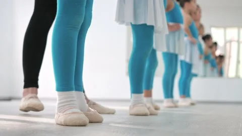 Close-up, the legs of young children in pointe shoes are trained in the ballet Stock Footage 233313208