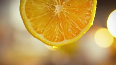 A close-up of a lemon half reveals its intricate fibers and seeds while a si Stock Footage 331311230