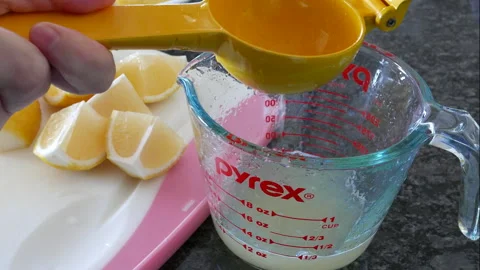 Close-Up of Lemon Juice Extraction: Kitchen Scene with Citrus Press Stock Footage 314497246