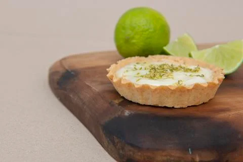 Close up of lemon pie on the table with citrus fruits. Traditional french swe Stock Photos