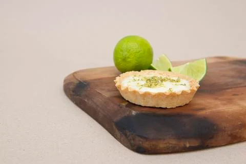 Close up of lemon pie on the table with citrus fruits. Stock Photos