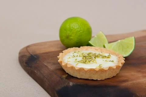 Close up of lemon pie on the table with citrus fruits. Stock Photos