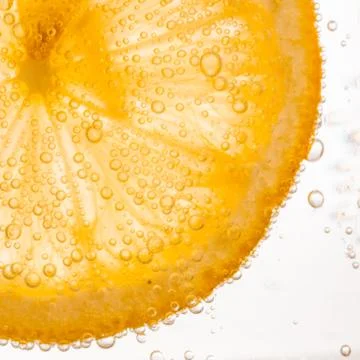 Close-up of lemon slice in clear water Stock Photos