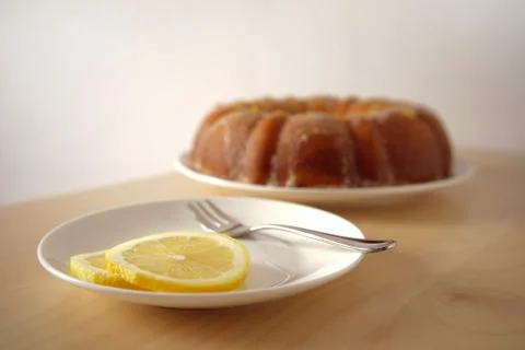 Close up of lemon slices with cake in the background Stock Photos