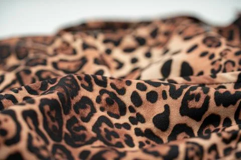 Close up of leopard print fabric texture with soft folds and pattern 写真素材
