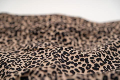 Close up of leopard print fabric texture with soft folds and pattern 写真素材