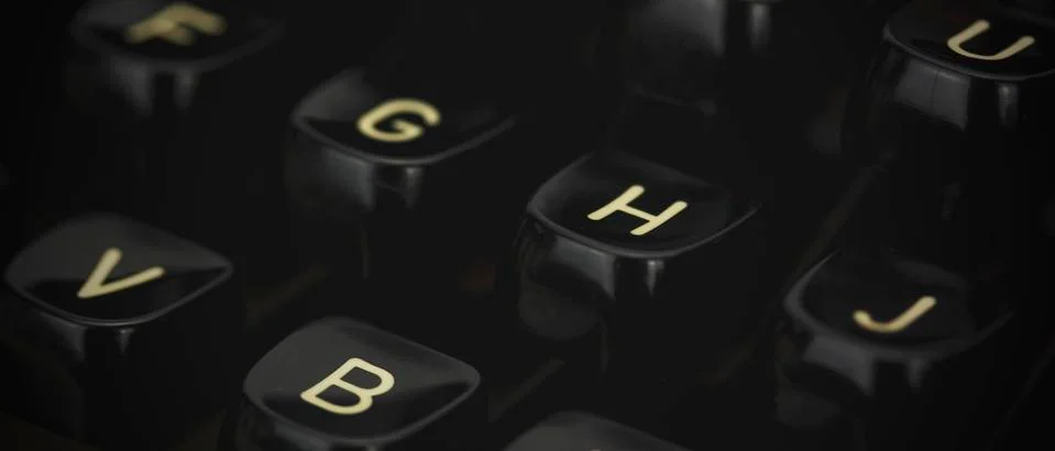 Close up of lettered keys on an old typewriter. Vintage filter applied. Stock Photos