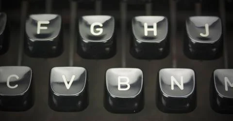 Close up of lettered keys on an old typewriter. Vintage filter applied. Stock Photos