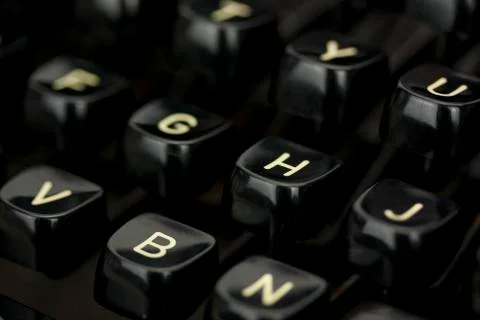 Close up of lettered keys on an old typewriter. Photos