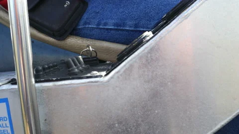 Close up on levers and controls alongside a seated person Stock Footage 152102468