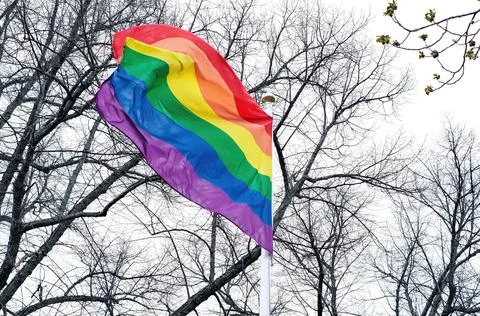 Close-up LGBT pride flag against a vibrant sky, evoking a sense of openness and Stock Photos