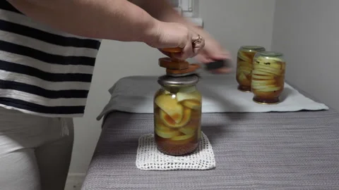 Close the lids on canned jars with a key Stock Footage 283775260
