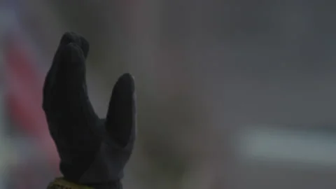 Close up on lifting hand of service technician showing stop Pitstop Car Racing Stock Footage 146191760
