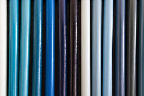 Close-up of light and dark blue colored pencils neatly lined up in pencil c.. Stock Photos