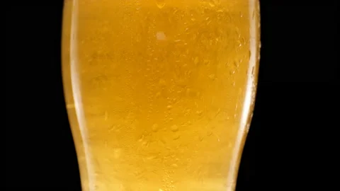 Close up Light beer is pouring into glass. Video stock 155436413