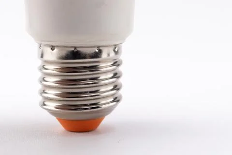 Close-up of a Light Bulb Base with Silver Threads and Orange Tip on White B.. Stock Photos