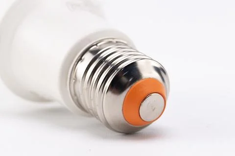 Close-up of a Light Bulb Base with Silver Threads, Orange Insulator, and Wh.. Stock Photos