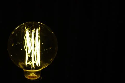 Close up light bulb on the black background Stock Photos