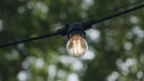 Close-up of a light bulb that illuminates the space with warm light Stock Footage 256054024
