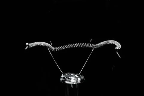 Close-up of the light bulb pole in the black background. Stock Photos