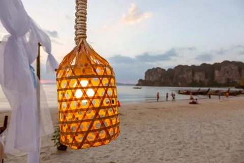 Close up of light bulb on the wire. Glow up In the lamp. Hanging on the beach Foto stock