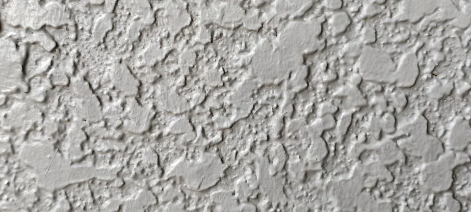 Close-up of a light-colored stucco texture wall. Stockfoto's