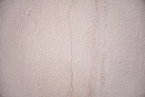 Close-up of a light crack on an off-white plaster wall Stock Photos