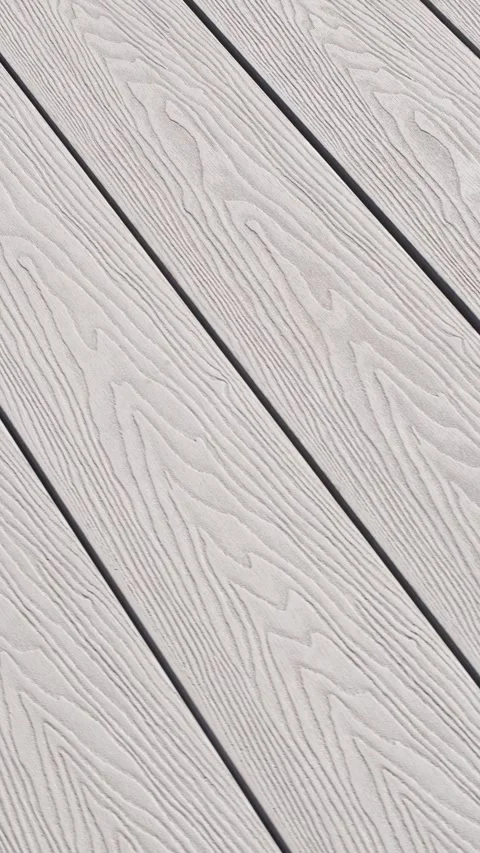 Close-up of light gray composite decking with pronounced wood texture. The surfa Stock Footage 312019108