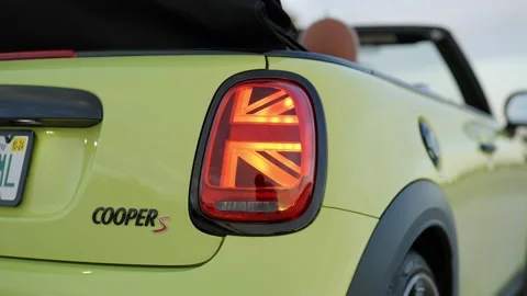 Close up of light green Mini Cooper S Convertible showing badge on trunk and Stock Footage 261247533