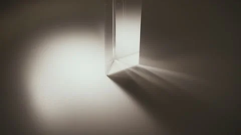 Close-up of light refracting through triangular glass prism, creating spectrum Stock Footage 313225017