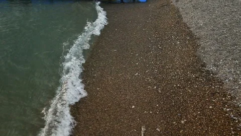 Close Up Of The Light Sea Waves Rolling On The Beach In Little Stones. Stock Footage 94652197