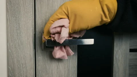 Close up of light switch and door handle wipe with antiseptic. Disinfection from Stock Footage 149964218
