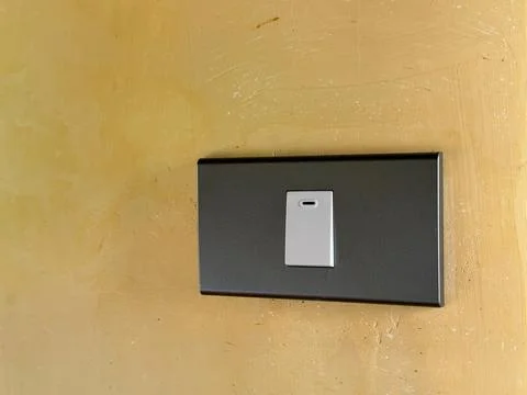 Close up of light switch with copy space on yellow wall Stock Photos