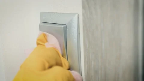 Close up of light switch wiped with antiseptic. Raising your hand to the switch Stock Footage 149966779
