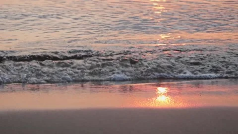 Close up of light waves on a sandy beach with red sunlight reflection. Stock-Footage 145212752