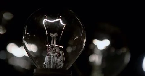 Close-up of a lightbulb on a black background. Stock Photos