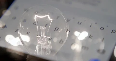 Close-up of a lightbulb on a black background. Stock Photos