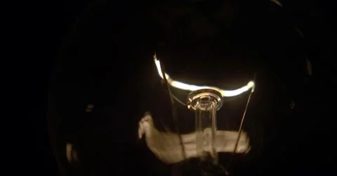 Close-up of a lightbulb on a black background. Stock Photos