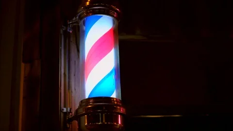 Close-up of a lighted barber pole spinning Stock Footage