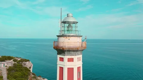 A close-up of a lighthouse against a clear blue sky. Beacon stands on a cliff Stock Footage 264639285
