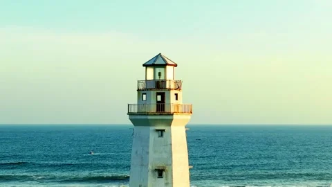 Close lighthouse tower against calm blue ocean Video stock 335439669