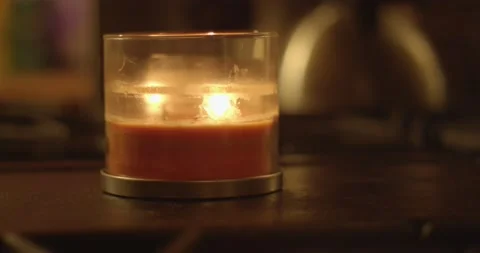 Close up lighting and placing burning red scented candle Video stock 233314535