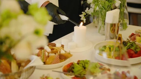 Close-up of lighting candles standing on a wedding dinner table with tasty food. Stock Footage 288106768
