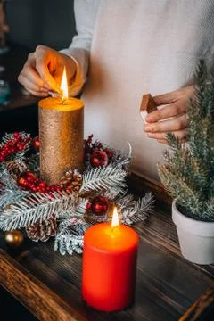 Close up of lighting first candle on Advent Wreath Celebrating Christmas or n Stock Photos