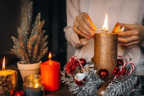 Close up of lighting first candle on Advent Wreath Celebrating Christmas or n Stock Photos