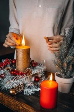 Close up of lighting first candle on Advent Wreath Celebrating Christmas or n Stock Photos