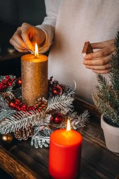 Close up of lighting first candle on Advent Wreath Celebrating Christmas or n Stock Photos