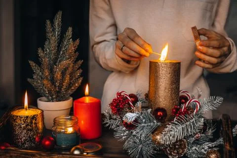 Close up of lighting first candle on Advent Wreath Celebrating Christmas or n Stock Photos